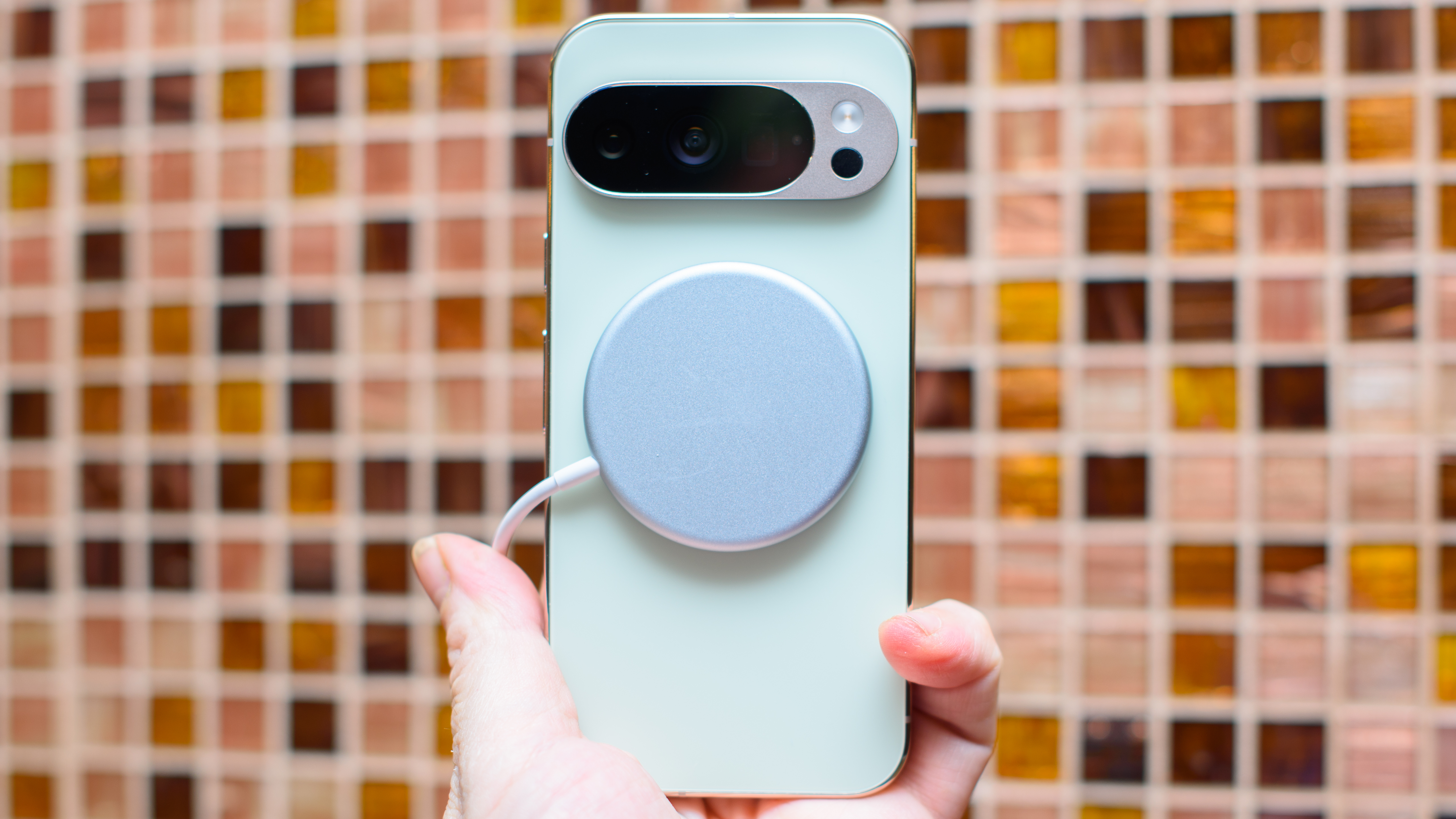 Google Pixel 10 Pro in Jade with checkered tile backsplash background