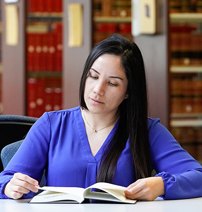 A student reads a book in the library.