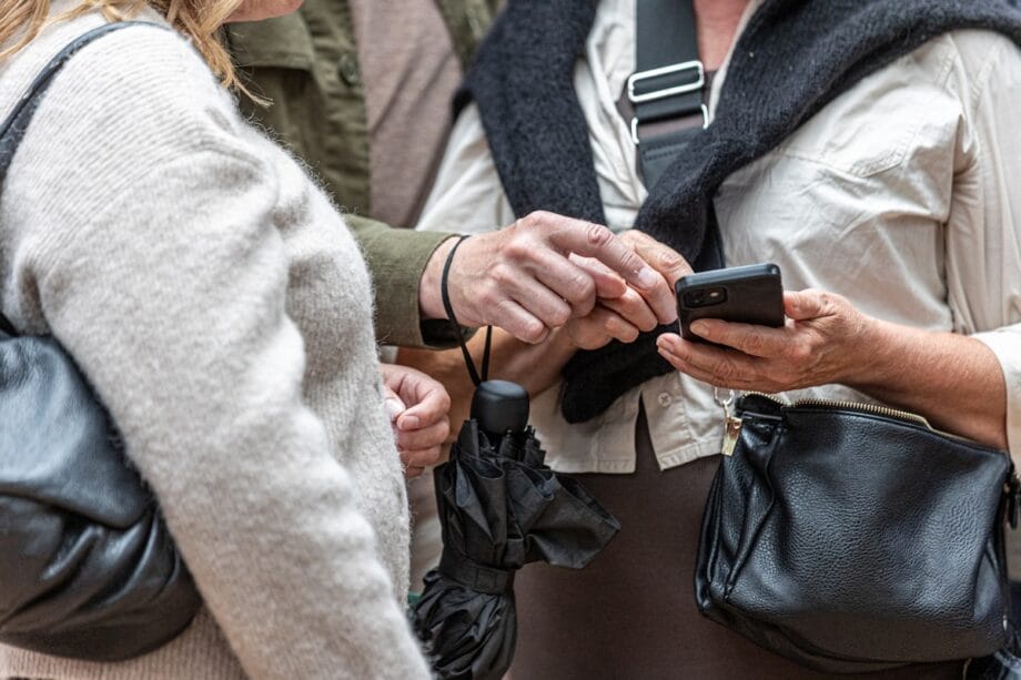 Two people looking at a smartphone screen together